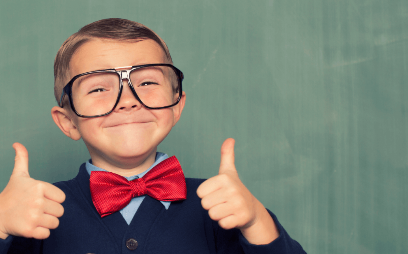 Close up portrait of child giving two thumbs up