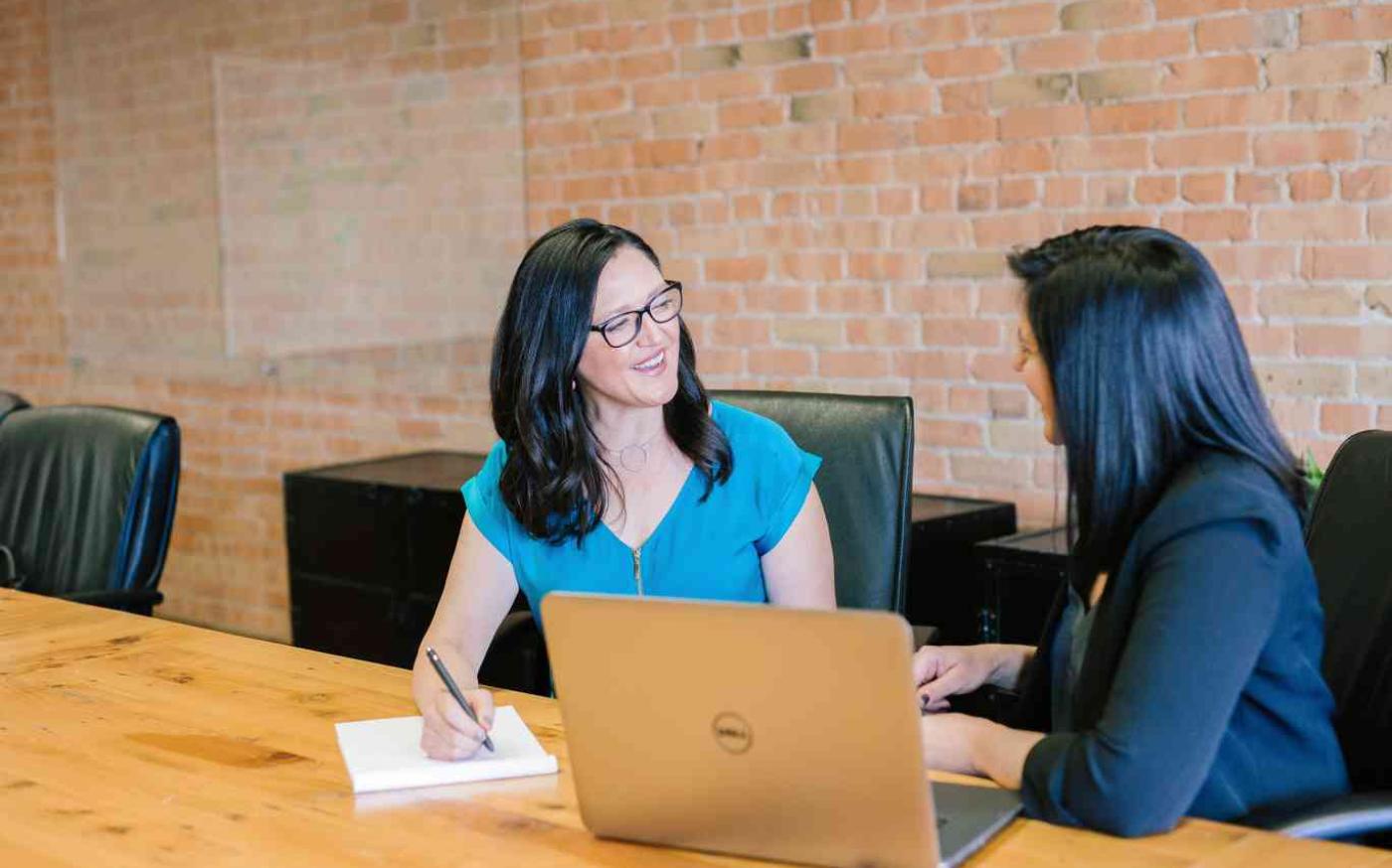 Two women meeting in an office space.